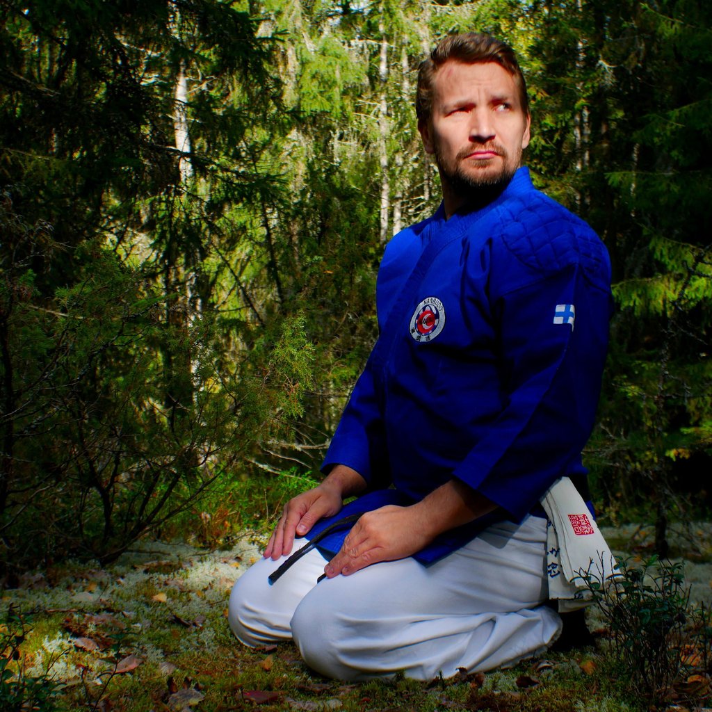 Jukka sitting in a forest